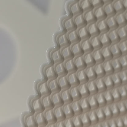 Close-up of a textured beige surface with wavy pattern