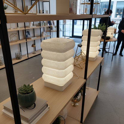 Stacked lamp on a shelf in a modern indoor setting
