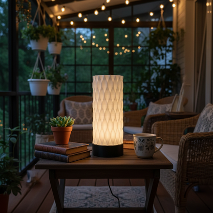 Decorative outdoor table lamp on a wooden table with a cozy evening setting.