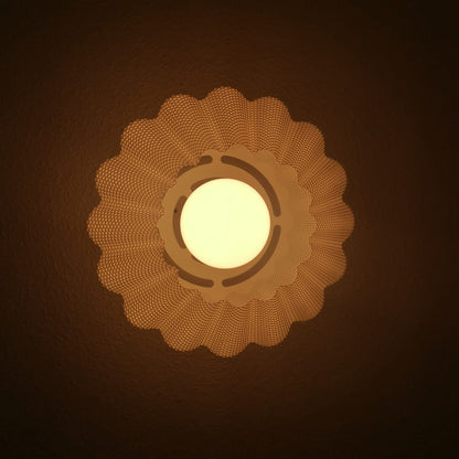 Decorative wall light fixture with a warm glow on a dark background