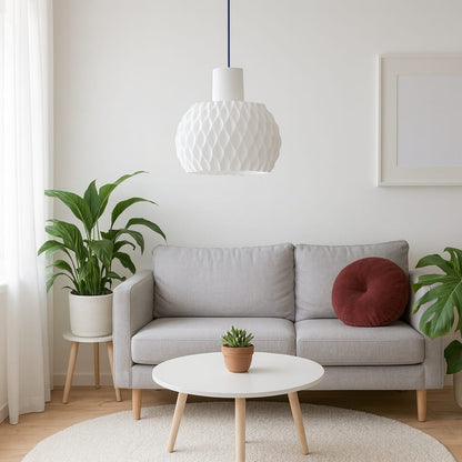 Modern living room with gray sofa, white coffee table, and decorative plants.