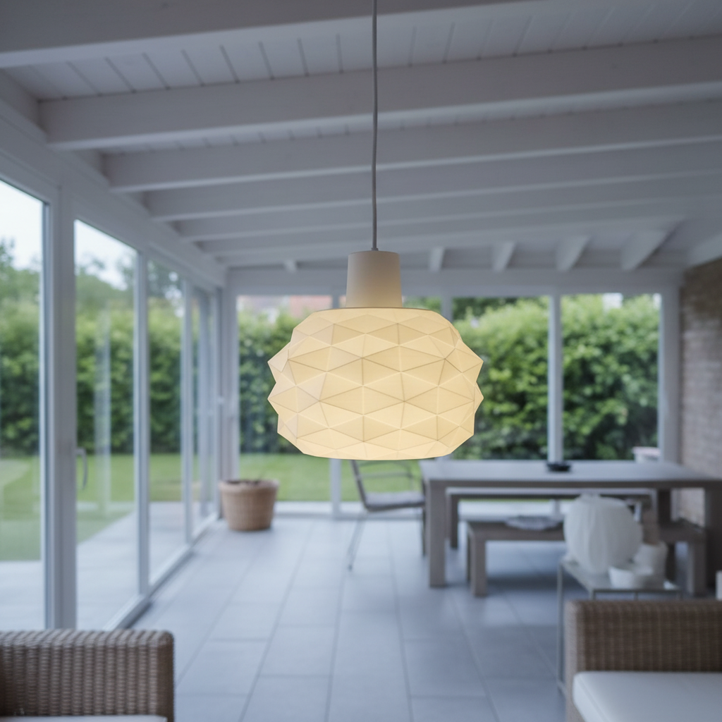 Faceted white pendant light hanging in a bright covered patio with glass walls and a garden view.