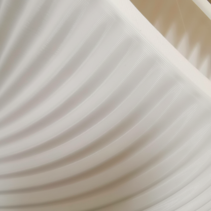 Close-up of ribbed spiral lampshade texture showing fine layered lines and smooth matte finish.