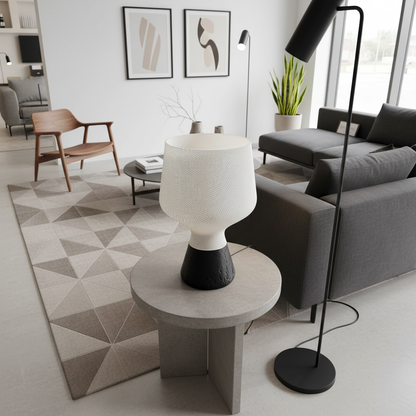 Modern living room with a gray sofa, wooden chair, and decorative lamp.