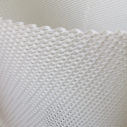 Close-up of a table lamp textured white fabric with a grid pattern
