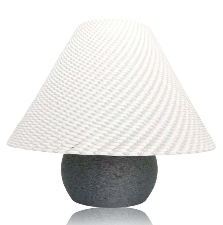 Table lamp with textured white shade and silver base on a white background