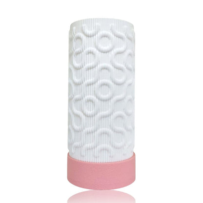 White textured table lamp with pink base on a white background