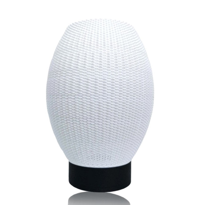 White textured lampshade on a black base against a white background