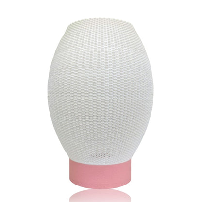 White textured lampshade with a pink base on a white background