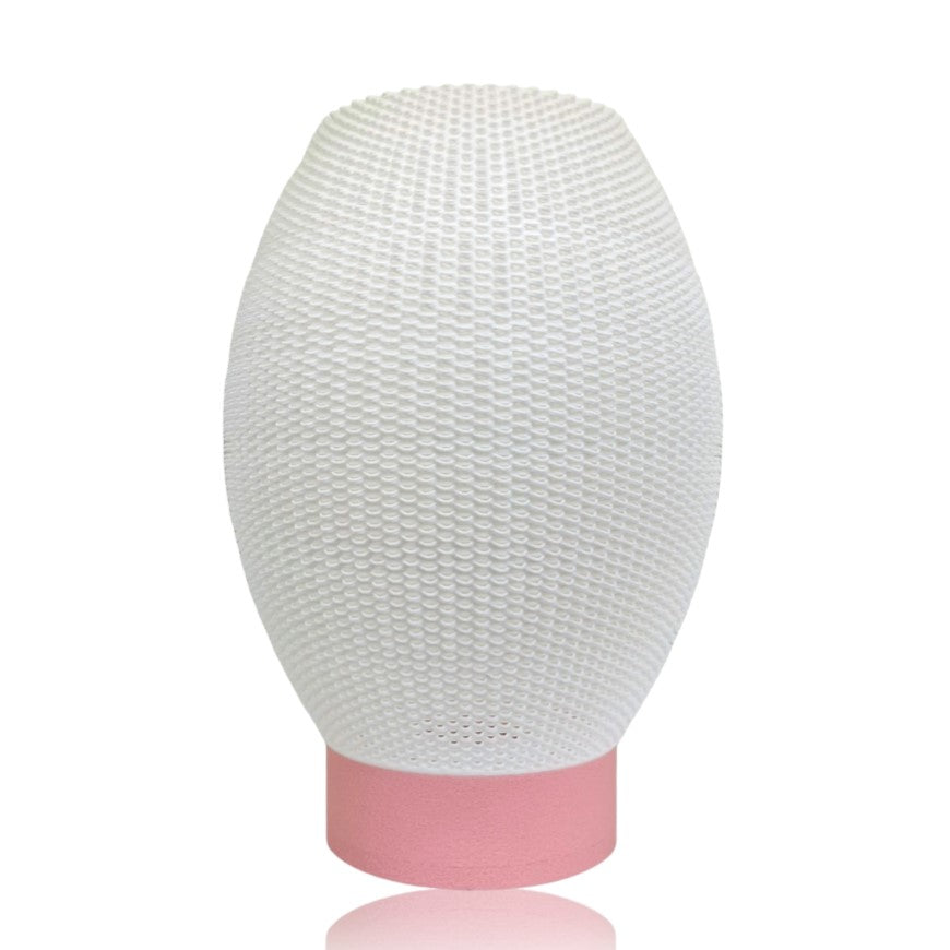 White textured lampshade with a pink base on a white background