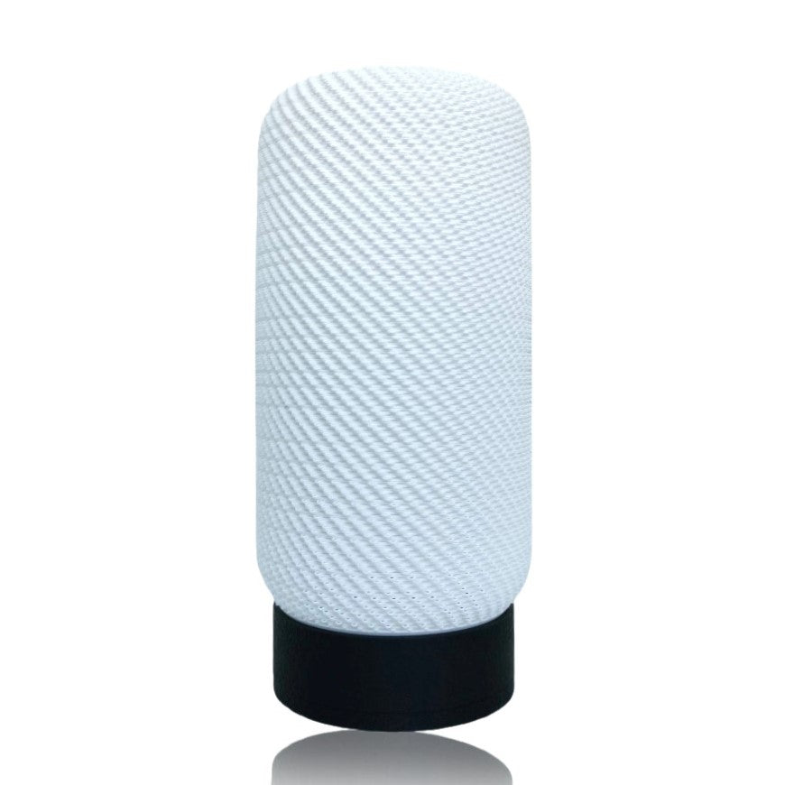 Textured white lamp with black base on a white background