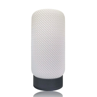 Textured white lampshade with silver base on a white background