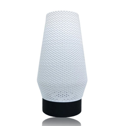 White textured table lamp with black base on a white background