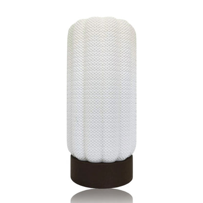 Textured white lamp with a brown base on a white background