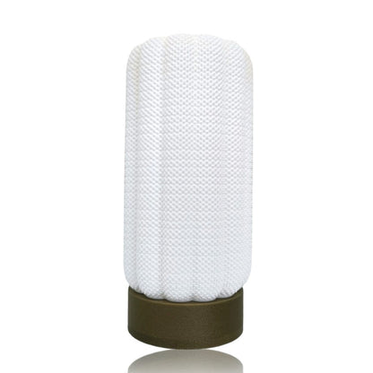 Textured white lamp with gold base on a white background