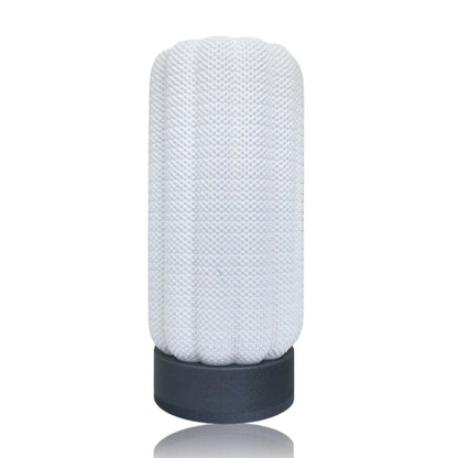 Textured cylindrical table lamp with a silver base on a white background