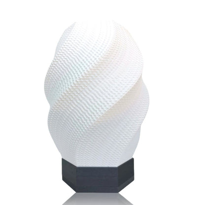 Textured white lamp with a silver base on a white background