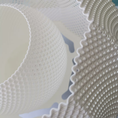 Macro close-up of the pendant lamp’s detailed woven texture and layered material design.