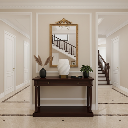 Foyer with a wooden console table, decorative lamp, and mirror on the wall.