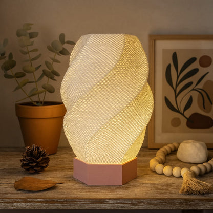 Decorative table lamp with a textured design on a wooden surface, surrounded by plants and decor items.