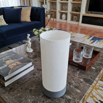 White textured table lamp on a marble coffee table in a living room setting
