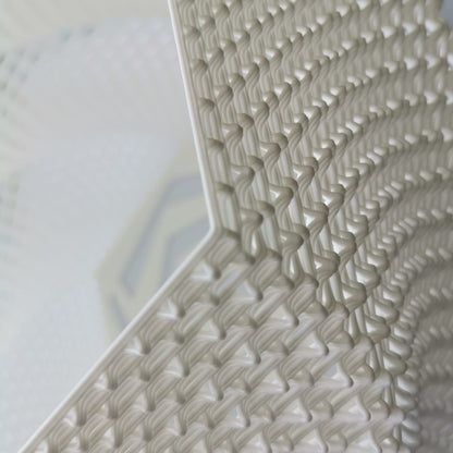 Close-up of a textured white surface with geometric pattern