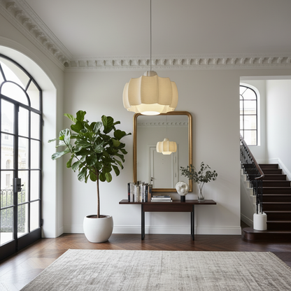 Elegant pendant lamp with softly textured shade illuminating a classic hallway with mirror, console table, and staircase.